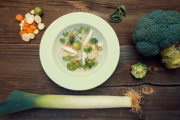 Vegetable Soup with Broccoli and Leek on Retro Wooden Table Background