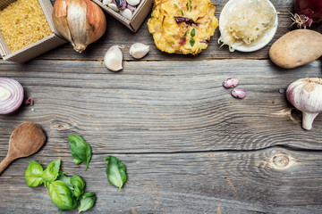 Cooking Ingredients with Potato Pancake on Wooden Background and Empty Space in the Middle