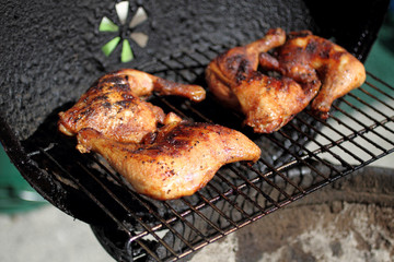 Grilled quarter chicken thighs and legs on the BBQ.