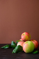 Ripe red apples on brown wooden background