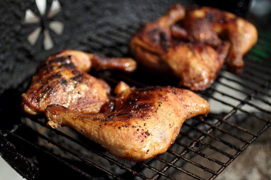 Grilled quarter chicken thighs and legs on the BBQ.