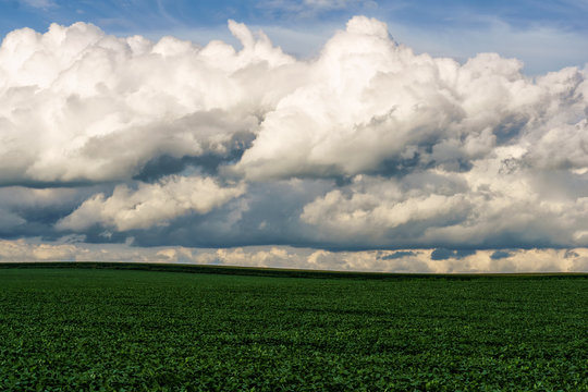 Thick, rolling clouds over a mid-western field.