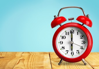 Blue Retro alarm clock on wooden table