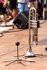 Trumpet on a wooden stage. Trumpet standing on the floor. Presentation of the brass band.