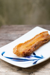 Crispy Pork Belly on wooden chopping board