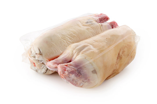 Pig hoof in vacuum packing on white background isolated