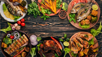 A set of food. Steak, Fish, Vegetables and Spices. On a wooden background. Top view. Copy space.