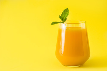 Mango Lassi dessert. Traditional Indian drink on yellow background. Copyspace