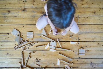 child plays a wooden constructor