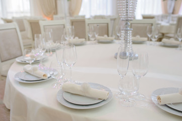 The banquet hall with round tables, with cutlery