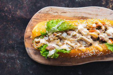 Long bread with mayonnaise on rustic background 
