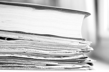Pile of newspapers and book, extremely close up. Paper texture for background 