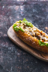 Long bread with mayonnaise on rustic background 