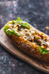 Long bread with mayonnaise on rustic background 