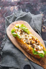 Long bread with mayonnaise on rustic background 