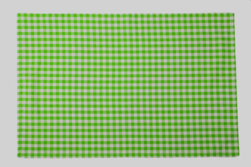 Green and white checkered napkin isolated on white background.