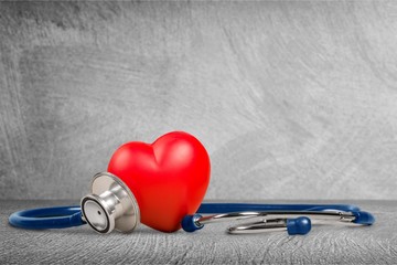 Red heart and a stethoscope on backgrouund
