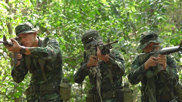 Soldier armed with a reconnaissance patrol in the woods. Concept of war, army and military.