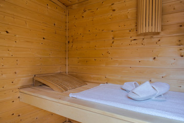 Obraz na płótnie Canvas A healthy wooden hot sauna with sauna accessories