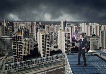 Fototapeta na wymiar A businessman looking with a spyglass against a city downtown