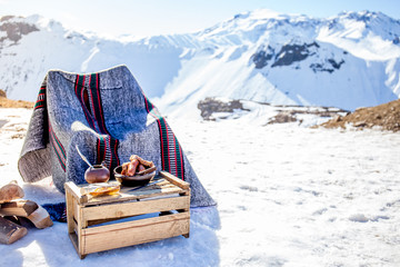 Winter picnic in chilean argentine snow mountaines Andes with hot meat food and drink yerba mate.