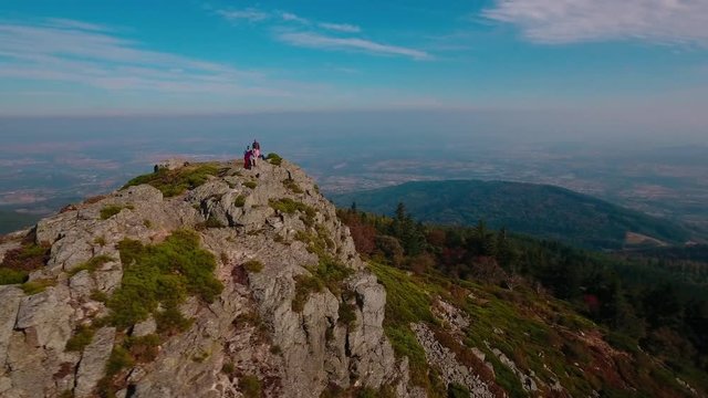 Drone shot around 5 people on a summit in a french national park.