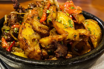 Ojahuri Georgian dish veal meat with potatoes in a clay plate for baking in the oven close-up on the table. horizontal view from above.