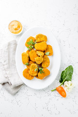 Healthy vegetarian nuggets with carrots, cauliflower and spinach. Vegetable nuggets. Vegan food. Top view, white background