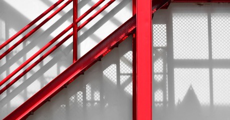 red fire escape staircase with shadow