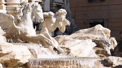 Detail of decorations and statues of the Fountain of TRevi on a sunny day