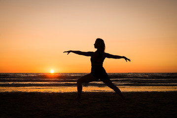 Silhouette of a girl practicing yoga