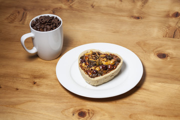 Mouth watering romantic breakfast for couples in a cozy and warm atmosphere and roasted cofee arabica beans on wood