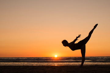 Silhouette of a girl practicing yoga