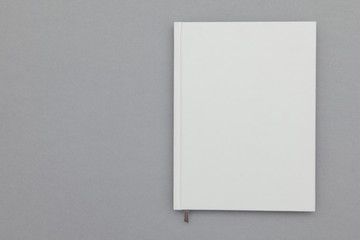 Hardback book cover mockup. White book on a grey background