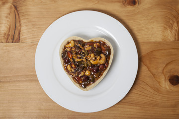 Romantic and cute heart shaped sweet pie on a wooden rustic counter and made with love