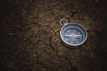 compass on cracked soil. - vintage style