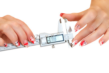 female hands with manicure and calipers 