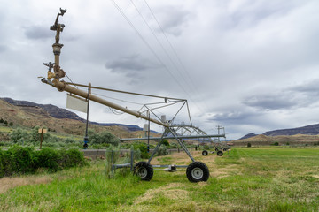 Wheel line irrigators machine in a field in desert, Central Oregon, usa.