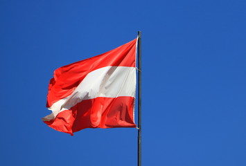 Naklejka na ściany i meble Flag of Austria against blue sky background