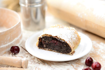 strudel (roll strudel) poppy seeds on a wooden board with flour