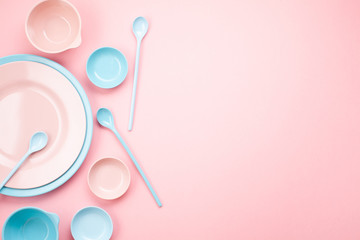 Mockup of pastel pink and blue plates and bowls over millennial pink background