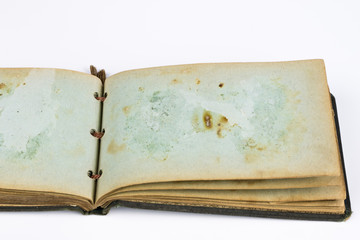 Old destroyed book on a white table. Old-style cover.