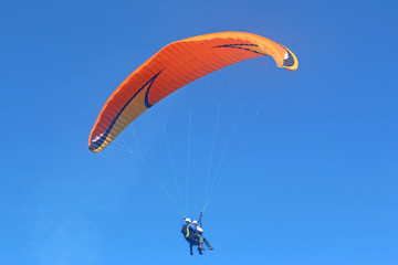 Tandem paraglider flying