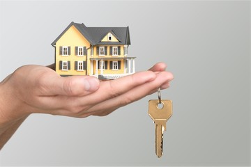 Businessman Holding House Model and Keys