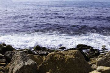 Fototapeta na wymiar Background of sea stones and the sea for design.