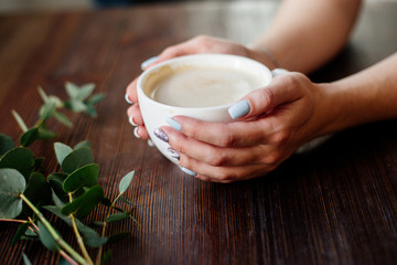 Cup of coffee in hands.