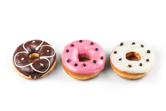 Colorful glazed donuts, top view over white background, isolated