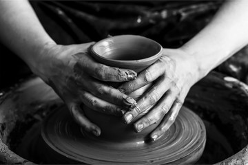 Fototapeta na wymiar Hand of potter doing clay pot