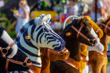 Fototapeta na wymiar Zebra,horse and donkey toys in the park