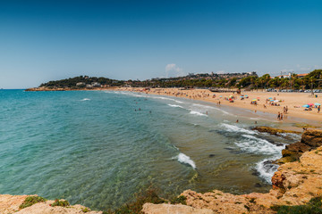 Vacationers in Arrabassada Beach, one of the famous golden sand beaches in the Spanish Costa Daurada